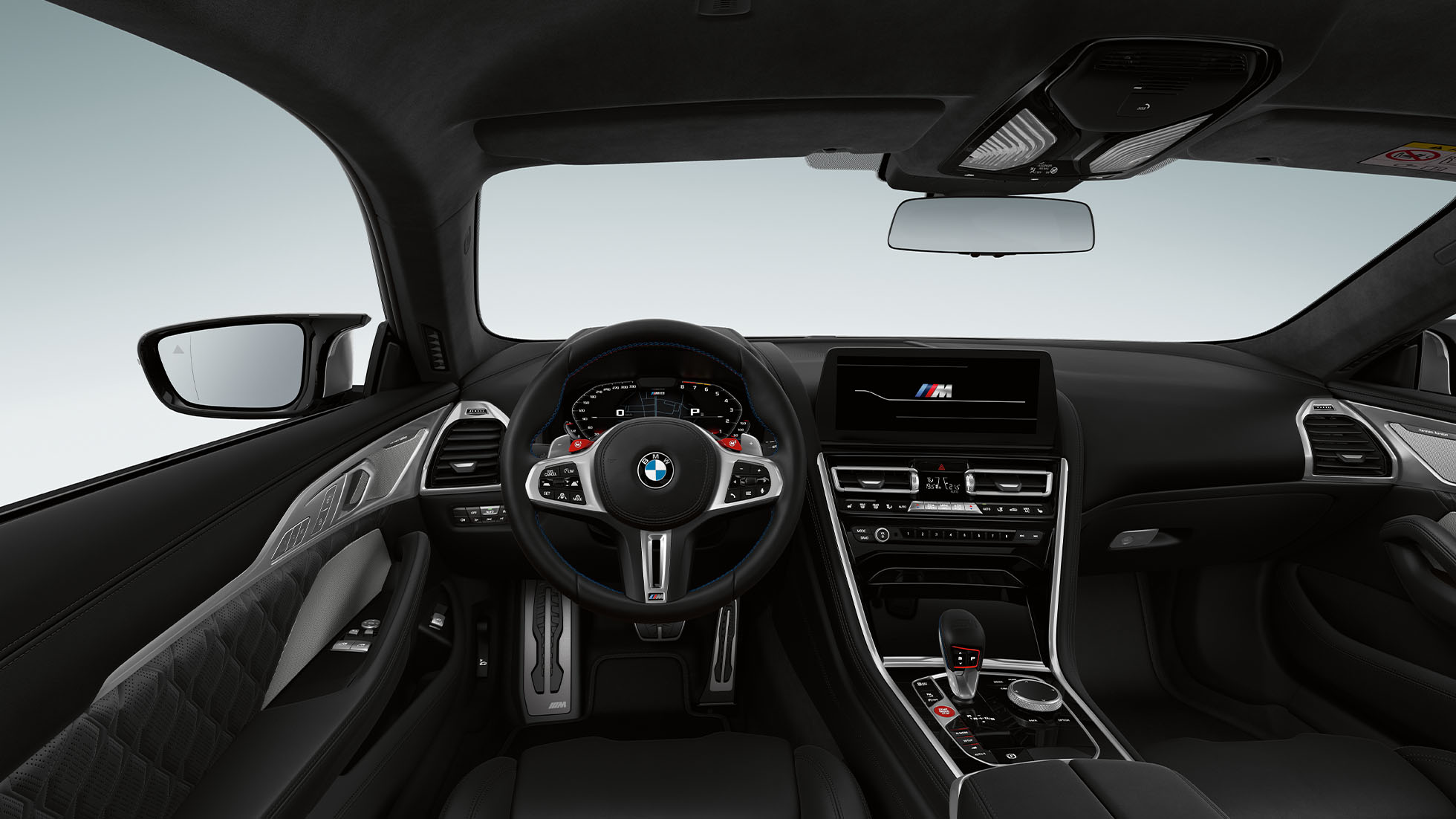 BMW M8 Competition Coupé, cockpit. BMW M8 Competition Coupé, cockpit at night with M leather steering wheel and blue ambient light.